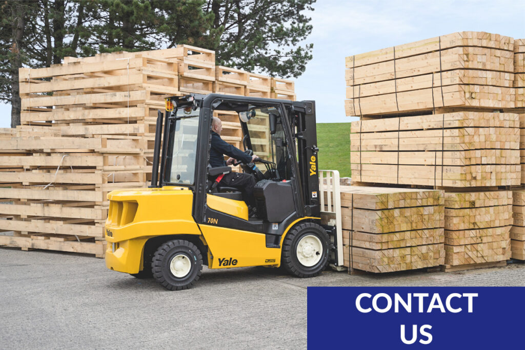 Yale forklift with operator moving stack of lumber in home center yard.